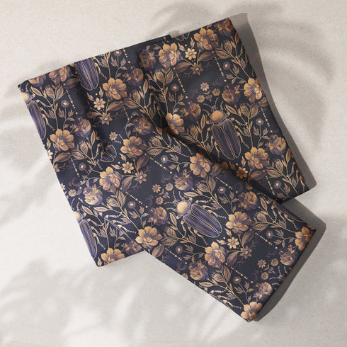 Set of four navy blue dining napkins featuring golden scarab beetles and botanical illustrations in a symmetrical pattern, sized 18x18 inches.